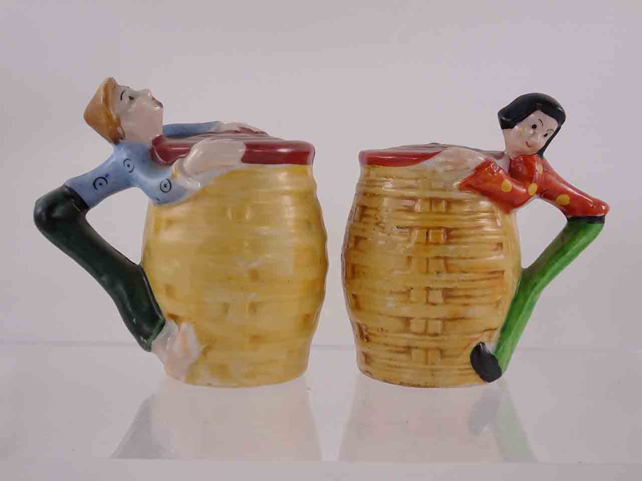 People hanging off sides of baskets salt and pepper shakers