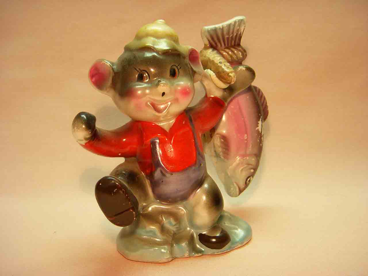 Shiny anthropomorphic bear holding fish salt and pepper shakers