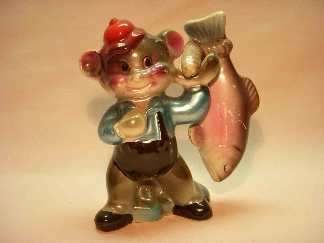 Shiny anthropomorphic bear holding fish salt and pepper shakers