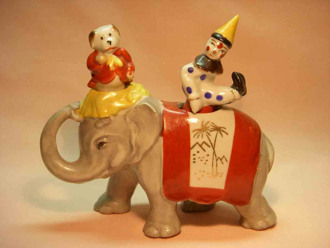 Walking elephant nodder with circus clown and dog as salt and pepper shakers